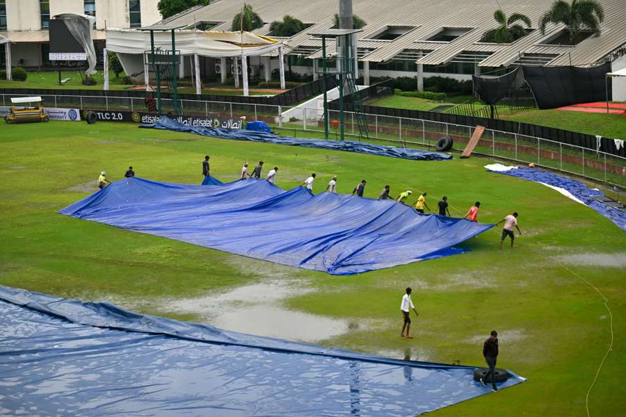 Groundsmen remove the cover after the one-off Test between Afghanistan and New Zealand was called off