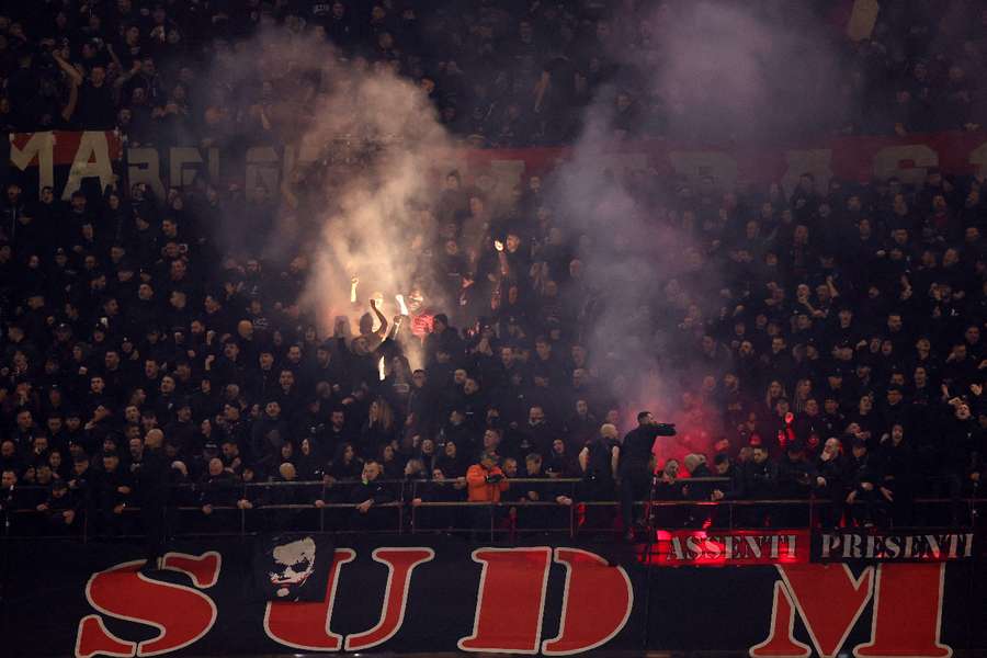 AC Milan fans lighting flares at the San Siro