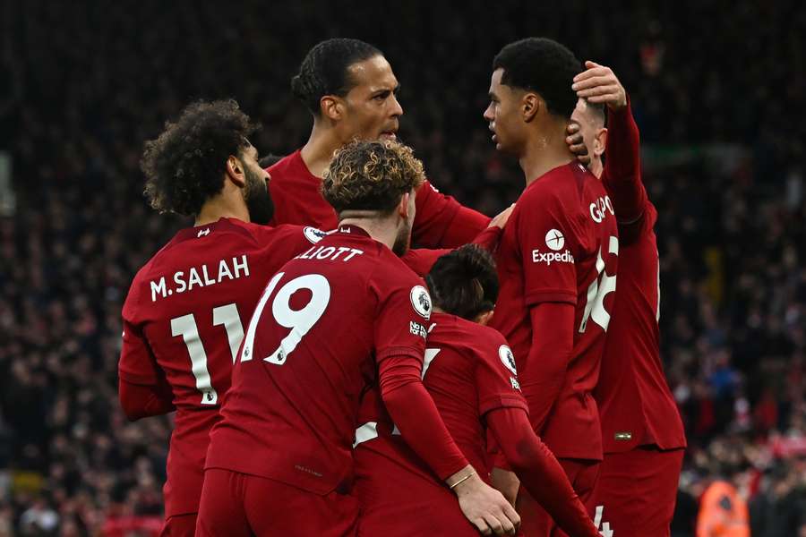 Liverpool's Dutch striker Cody Gakpo (2R) celebrates with teammates