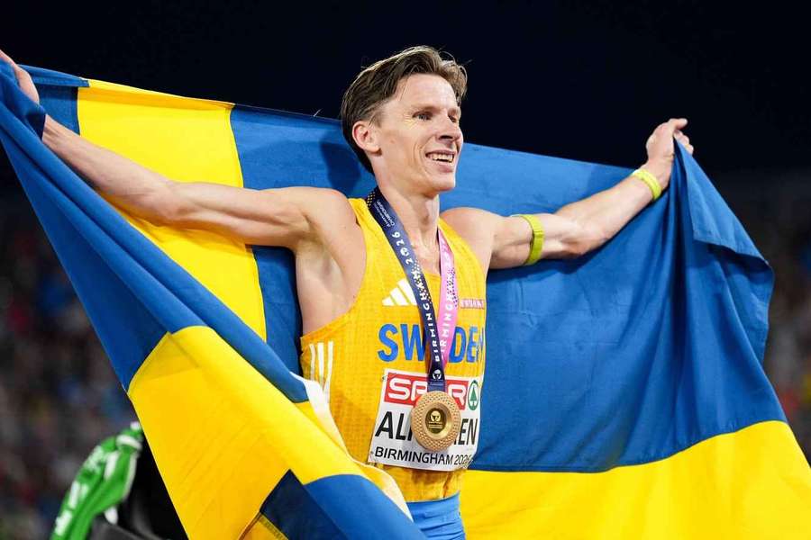 Almgren celebrates winning the 10,000m title Almgren celebrates winning the 10,000m title