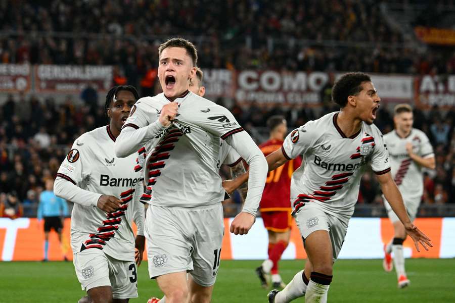 Bayer Leverkusen midfielder Florian Wirtz celebrates with teammates after scoring his team's first goal