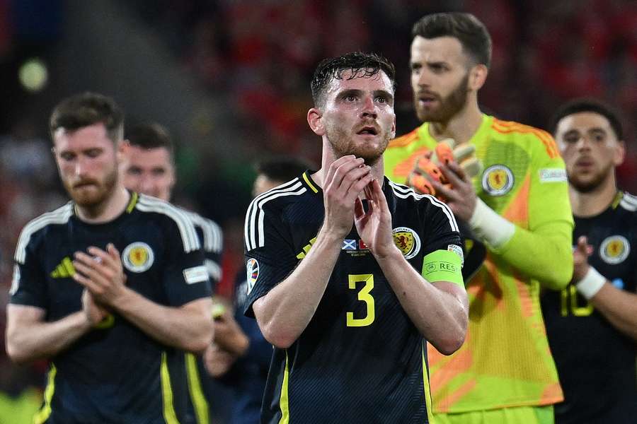 Scotland defender Andrew Robertson (C) and his teammates applaud the fans