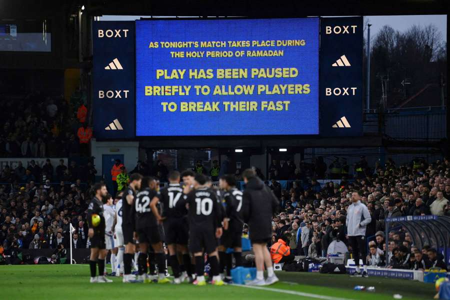 A big screen displays a message as play stops to allow players to break their fast for Ramadan