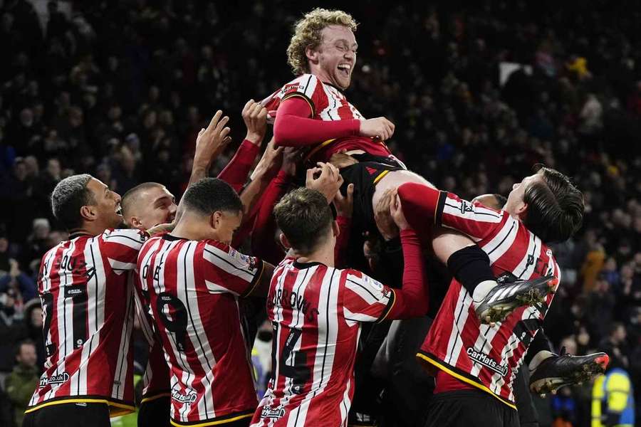 Match-winner Tom Davies is held aloft after the final whistle