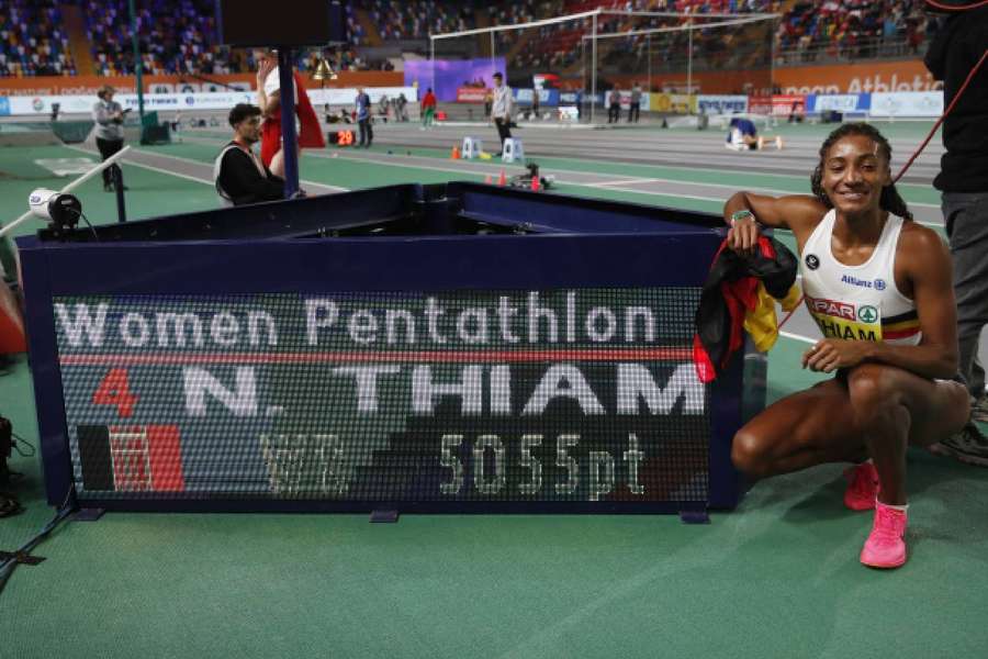 Thiam poses with the screen as she sets a new world record