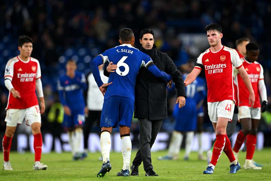 Thiago Silva of Chelsea embraces Mikel Arteta, Manager of Arsenal, following the Premier League match