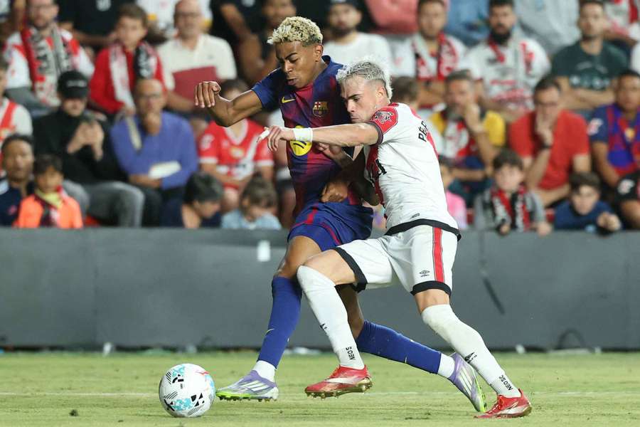 Lamine Yamal battles with Pep Chavarria during the pulsating draw