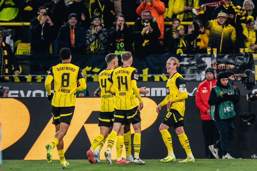 Dortmund players celebrate a goal against Freiburg in the Bundesliga