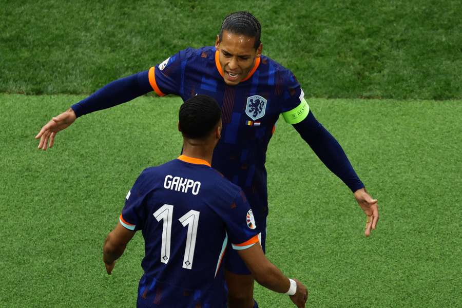 Netherlands' Virgil van Dijk and Cody Gakpo celebrating a goal together at Euro 2024