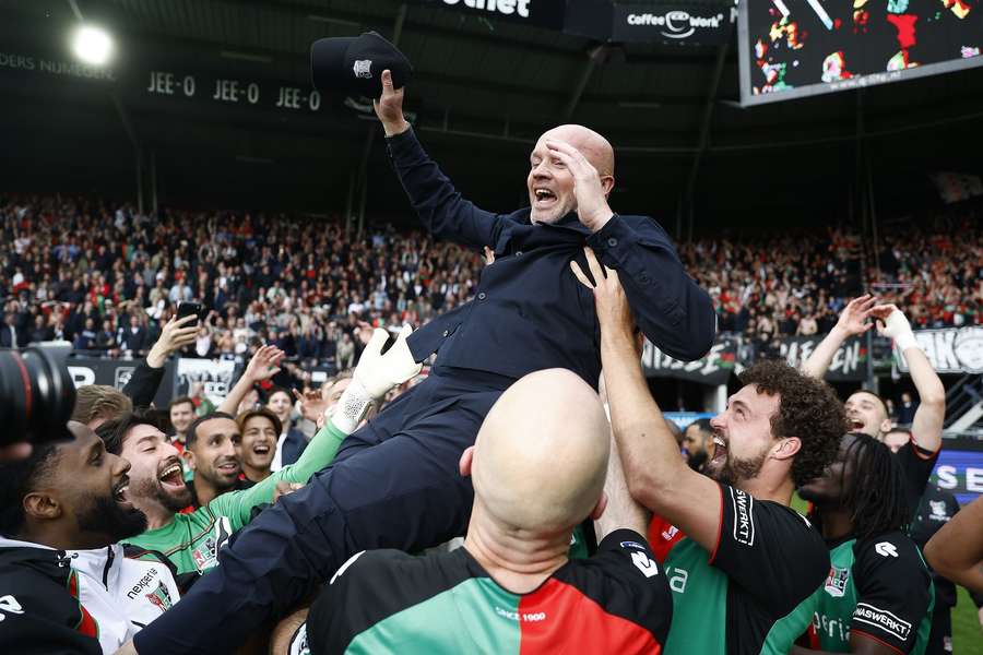 Dick Schreuder is lifted up by NEC players after clinching a UEFA Champions League ticket