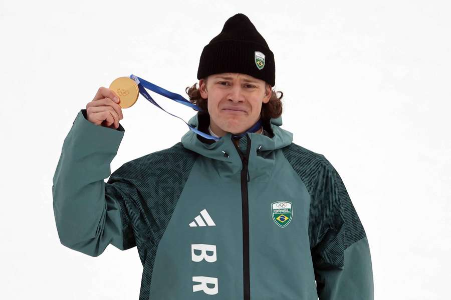 Gold medallist Lucas Pinheiro Braathen of Brazil celebrates on the podium after winning the men's giant slalom
