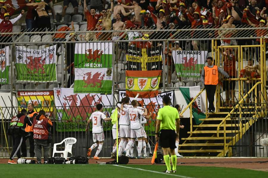 Wales celebrate an injury-time equaliser by Nathan Broadhead