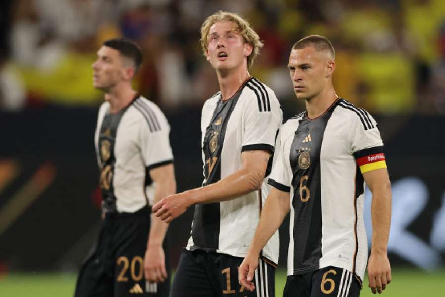 Joshua Kimmich and Julian Brandt look dejected after the match