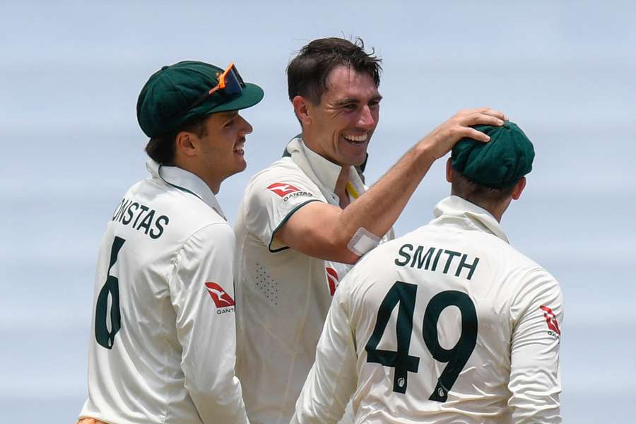 Sam Konstas, Pat Cummins and Steve Smith celebrate a wicket during the second Test against the West Indies.