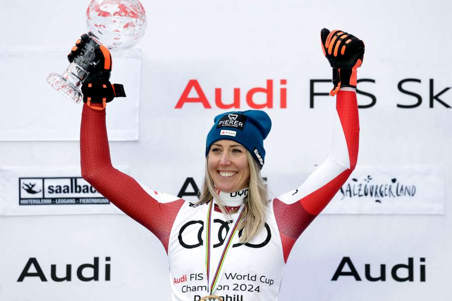 Cornelia Hutter lifts the downhill globe after victory in Saalbach