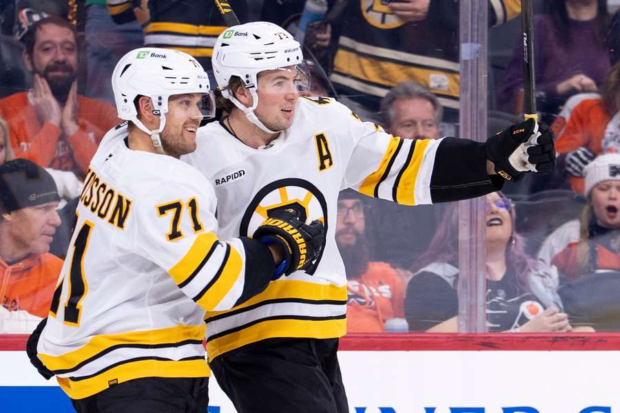 Charlie McAvoy (right) celebrates goal with Viktor Arvidsson (left)