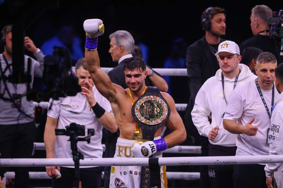 Tommy Fury (C) celebrates