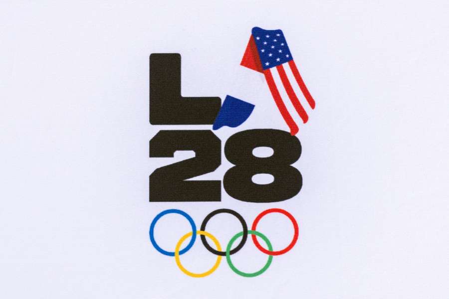 A logo for the 2028 Olympic Games is pictured with the French and US flags upon the arrival of the Olympic flag at LAX Airport