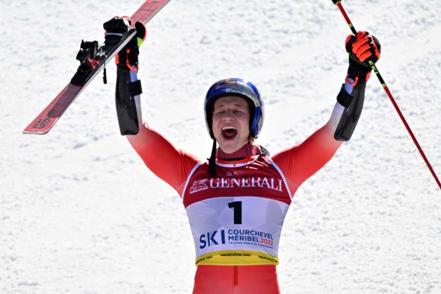 Marco Odermatt celebrates after winning gold