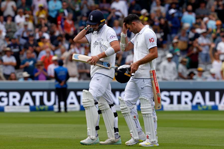 England's Josh Tongue (L) and James Anderson (R) leave the field after Australia win on day five of the second Ashes Test