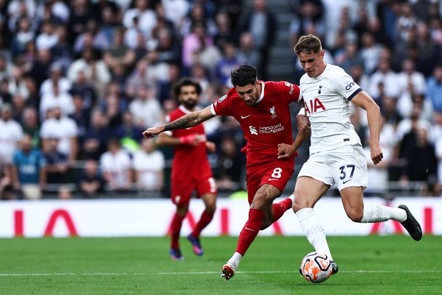 Liverpool's Hungarian midfielder #08 Dominik Szoboszlai fights for the ball with Tottenham Hotspur's Dutch defender #37 Micky van de Ven