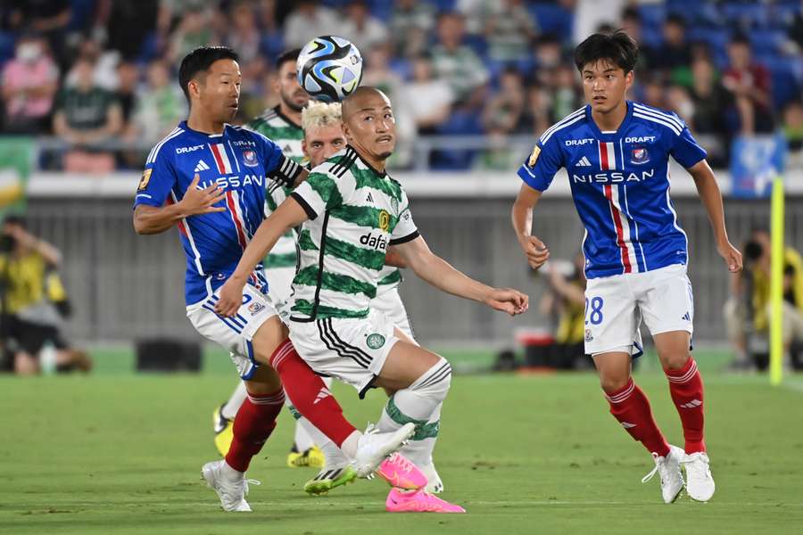 Celtic's forward Daizen Maeda (C) fights for the ball against players of Japan's Yokohama F. Marinos