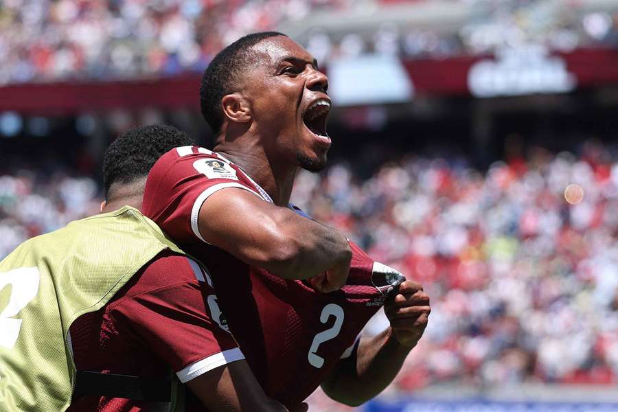 Pedro Miguel of Qatar celebrates Boualem Khoukhi's late goal Pedro Miguel of Qatar celebrates Boualem Khoukhi's late goal