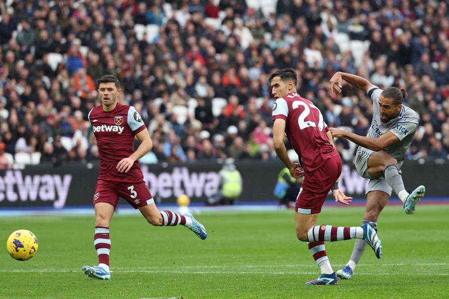 Dominic Calvert-Lewin (R) shoots to score the opening goal