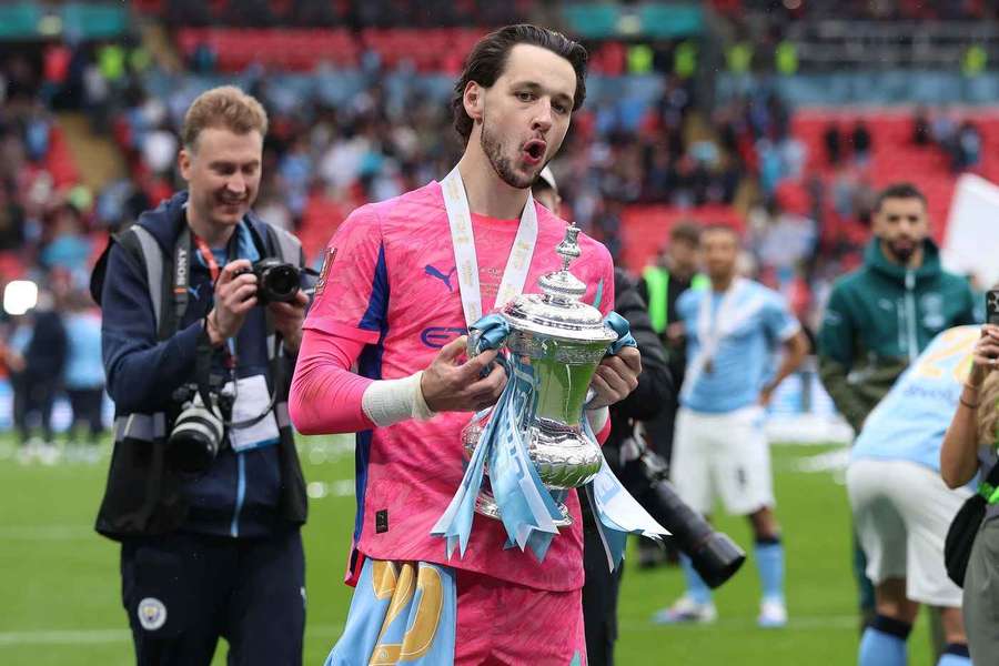 James Trafford holds the FA Cup after Man City beat Chelsea in last season's final