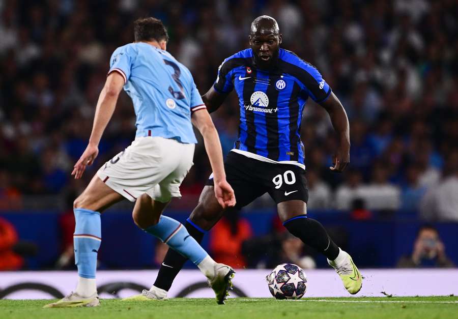 Romelu Lukaku controls the ball as he is marked by Ruben Dias