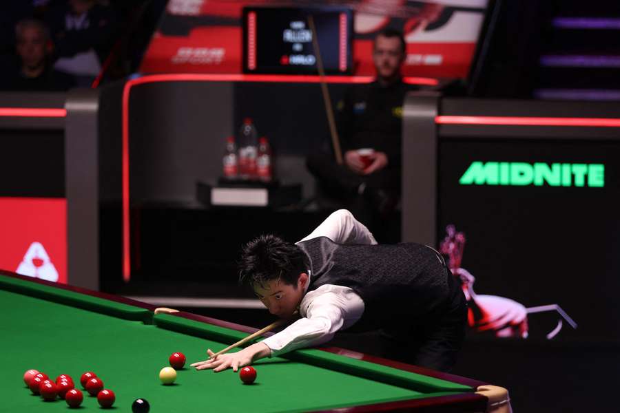 Wu Yize of China plays a shot during the semi-final match against Mark Allen