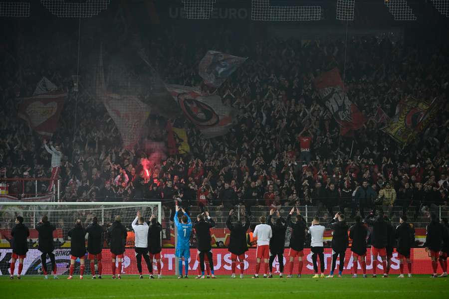 Union Berlin's players celebrate with supporters