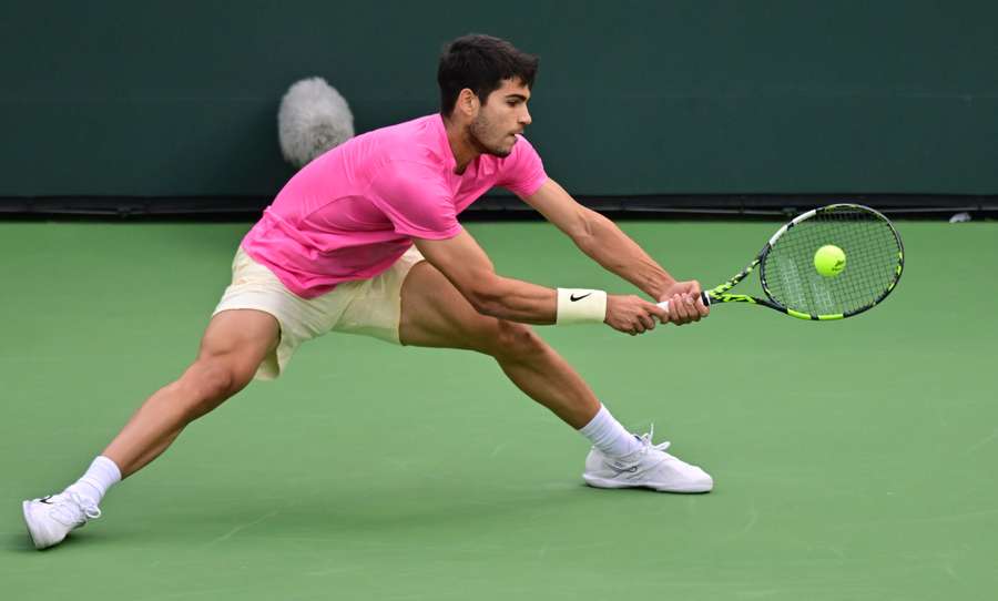 Carlos Alcaraz of Spain hits a backhand return to Daniil Medvedev of Russia 