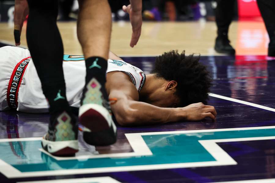Jaylen Wells on the ground after receiving contact from K.J. Simpson in the Memphis Grizzles' NBA game on Tuesday.