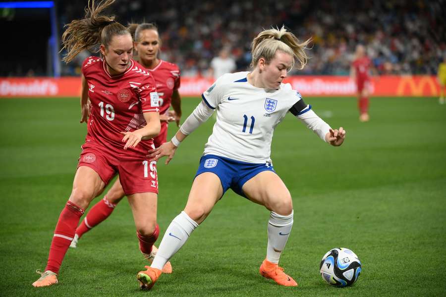 England's forward #11 Lauren Hemp (R) fights for the ball with Denmark's midfielder #19 Janni Thomsen