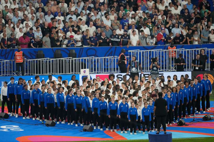 A choir performs before the Rugby World Cup match between France and New Zealand