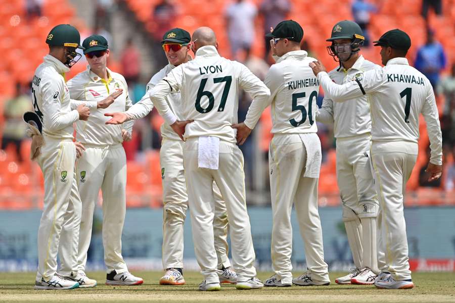 Australia's Nathan Lyon (C) celebrates with teammates after taking a wicket