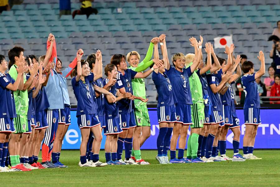 Japan's players celebrate the victory that sent them to Saturday's Asian Cup final.