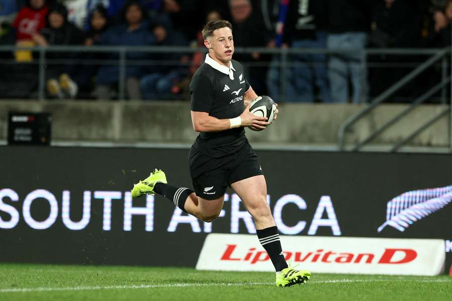 Cam Roigard runs across the line to score his first try against France in July.