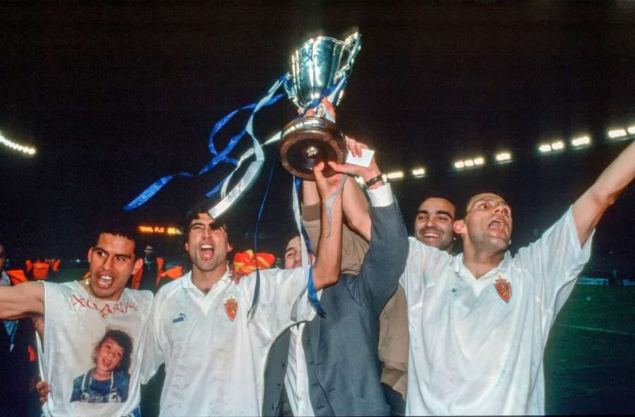 Poyet (right) celebrating winning the Cup Winners' Cup during his time with Zaragoza Poyet (right) celebrating winning the Cup Winners' Cup during his time with Zaragoza