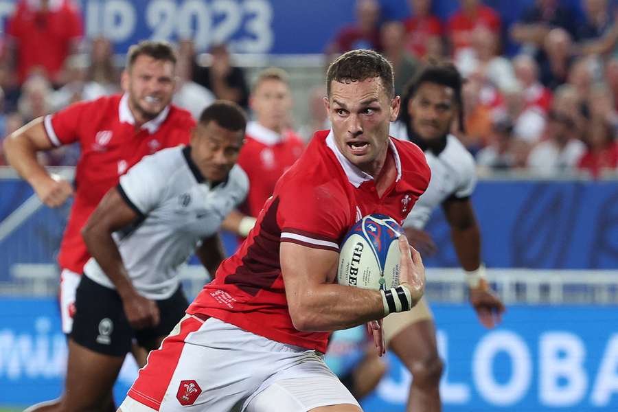 Wales' outside centre George North runs to score a try against Fiji