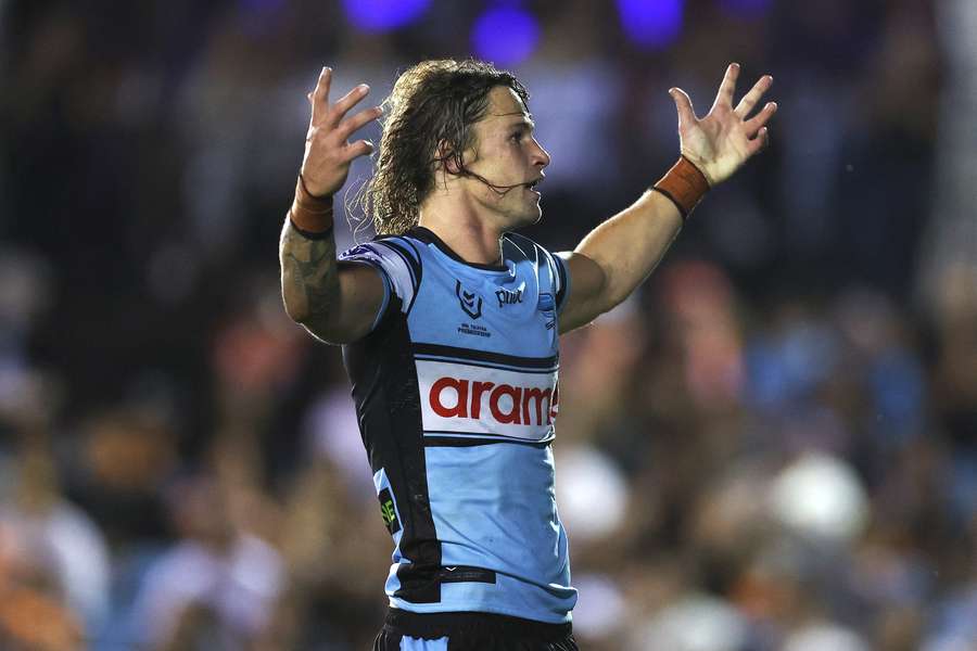Cronulla's Nicho Hynes celebrates a try during their pummeling of Wests Tigers. 