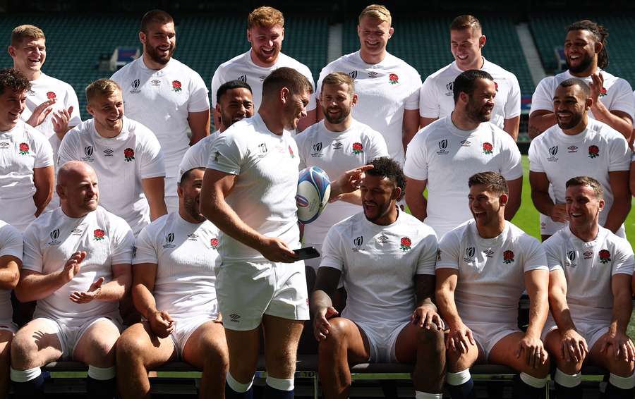 Owen Farrell jokes with teammates as they prepare to pose for a group photo