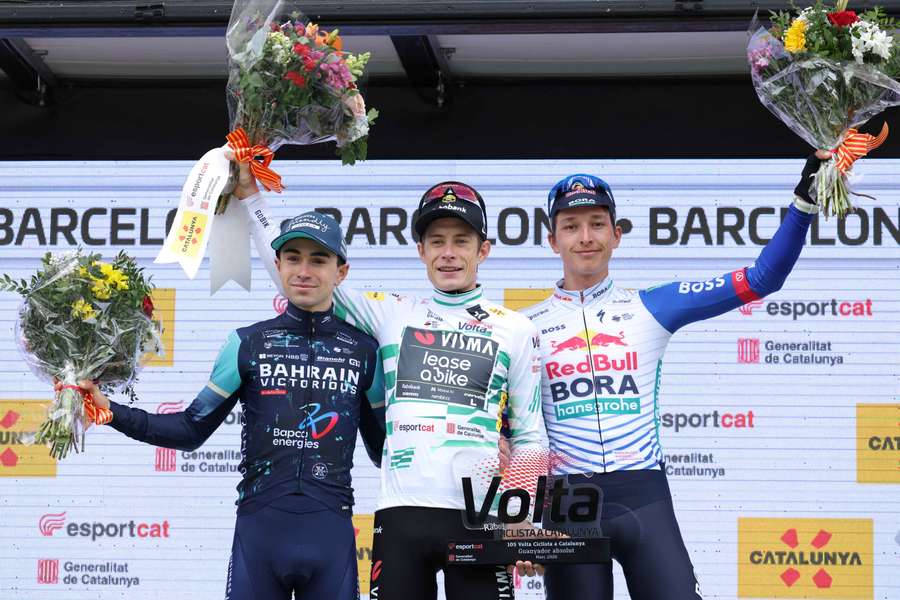 Winner Jonas Vingegaard (C), second-placed Lenny Martinez (L) and third-placed Florian Lipowitz celebrate on the podium of the 2026 Volta a Catalunya Winner Jonas Vingegaard (C), second-placed Lenny Martinez (L) and third-placed Florian Lipowitz celebrate on the podium of the 2026 Volta a Catalunya