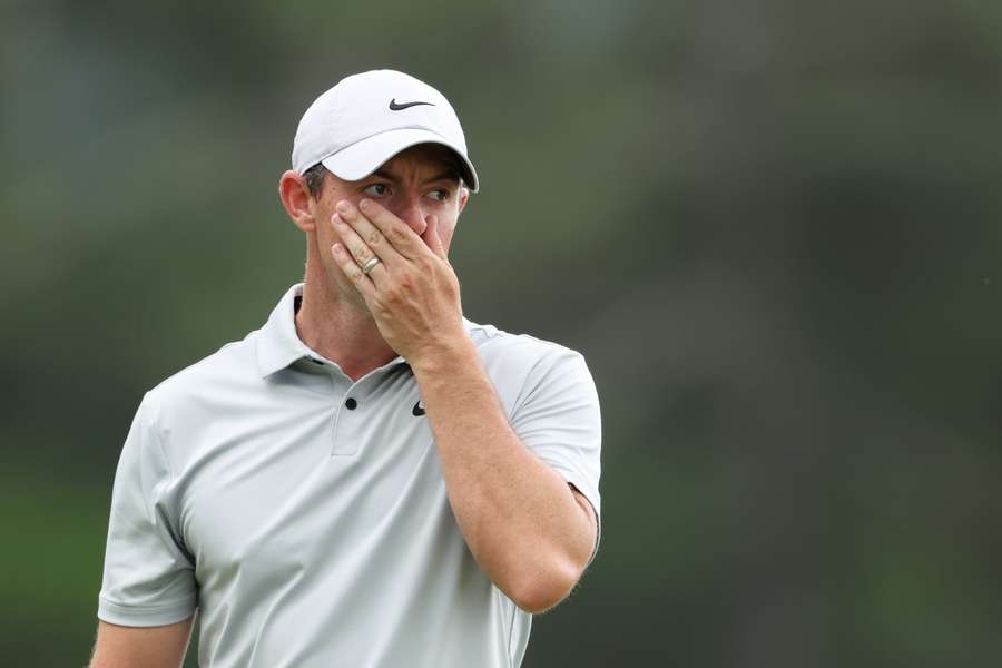 Rory McIlroy reacts to a putt on the 18th green