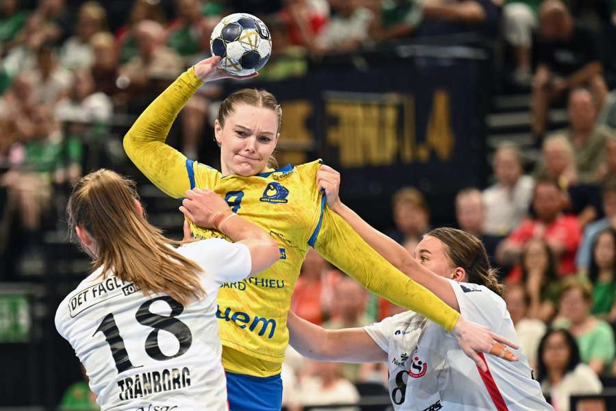 Metz's Danish left back Anne Mette Hansen (C) jumps to shoot during the EHF FINAL4 Women third-place match 