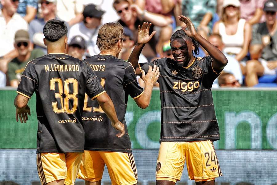 Ajax's Jorthy Mokio (R) celebrates with Mika Godts and Marcos Leonardo after scoring against PEC Zwolle
