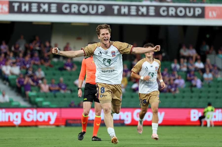 Newcastle's Lachlan Bayliss celebrates a goal scored away at Perth Glory. 