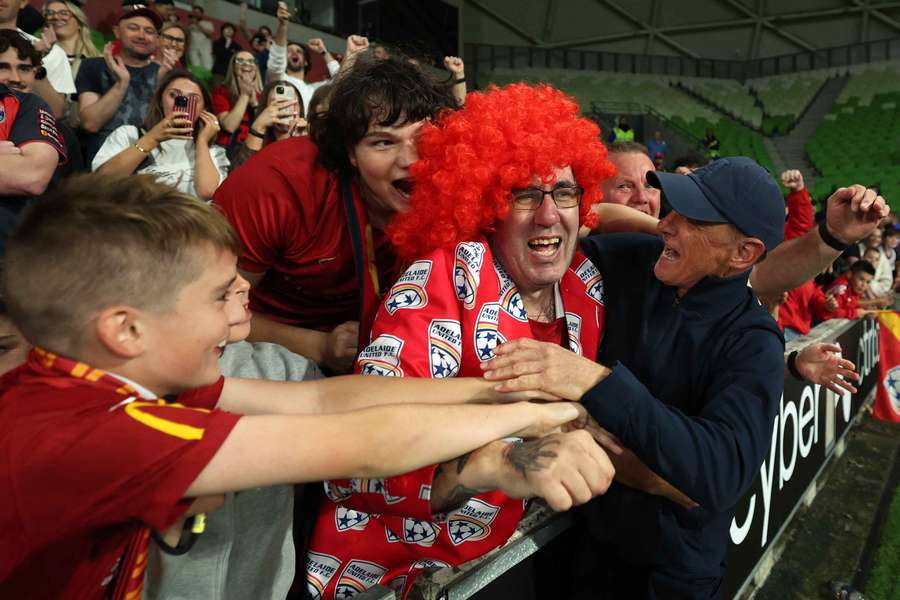 Adelaide United Airton Andrioli celebrates their win over Melbourne City with travelling supporters. 
