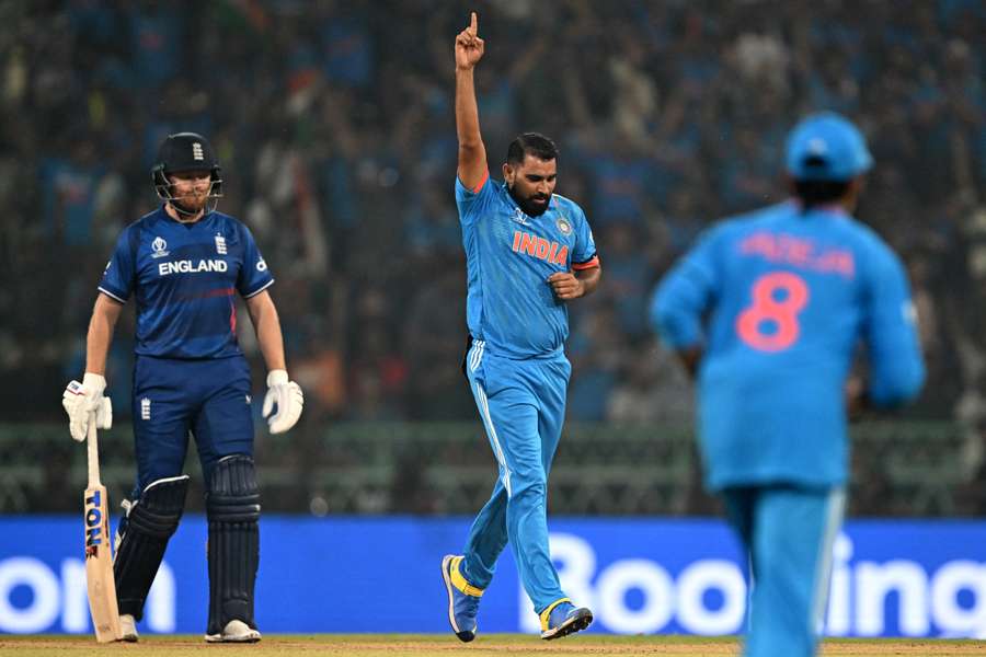 India's Mohammed Shami (C) celebrates after taking the wicket of England's Ben Stokes as England's Jonny Bairstow (L) watches